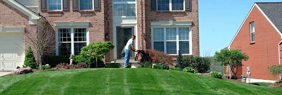 man using lawn mower