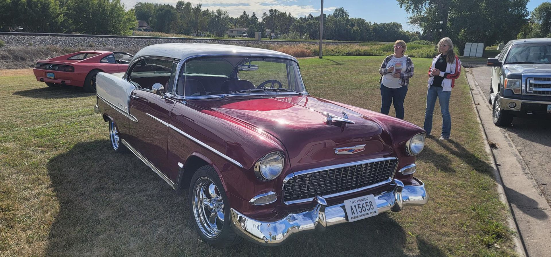 Two women looking at a Chevrolet Bel Air
