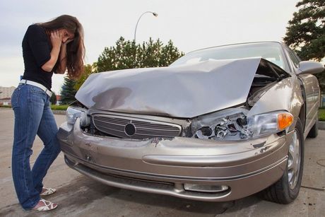 Woman standing in front of car - accident