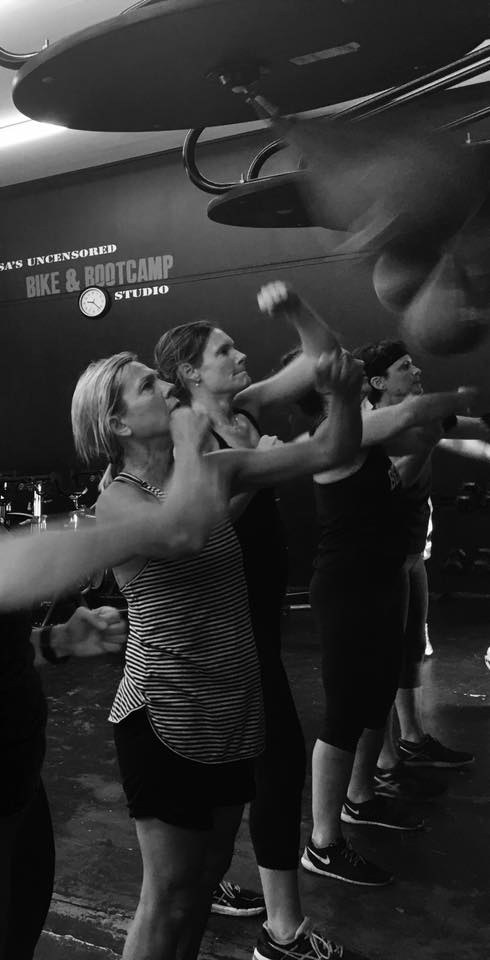 A group of people are standing next to each other in a gym.