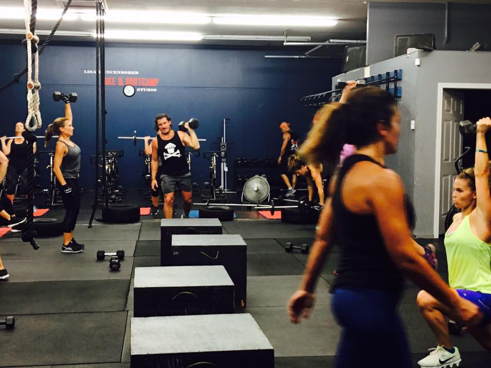 A group of people are doing exercises in a gym