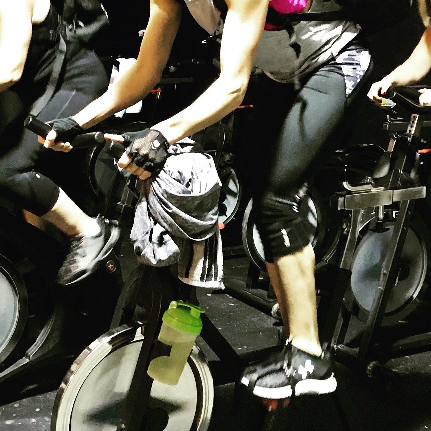A group of people are riding exercise bikes in a gym
