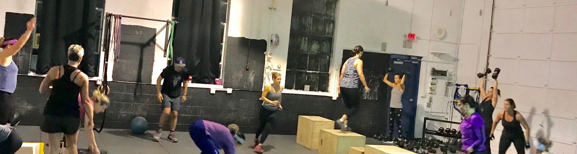 A group of people are doing exercises in a gym.