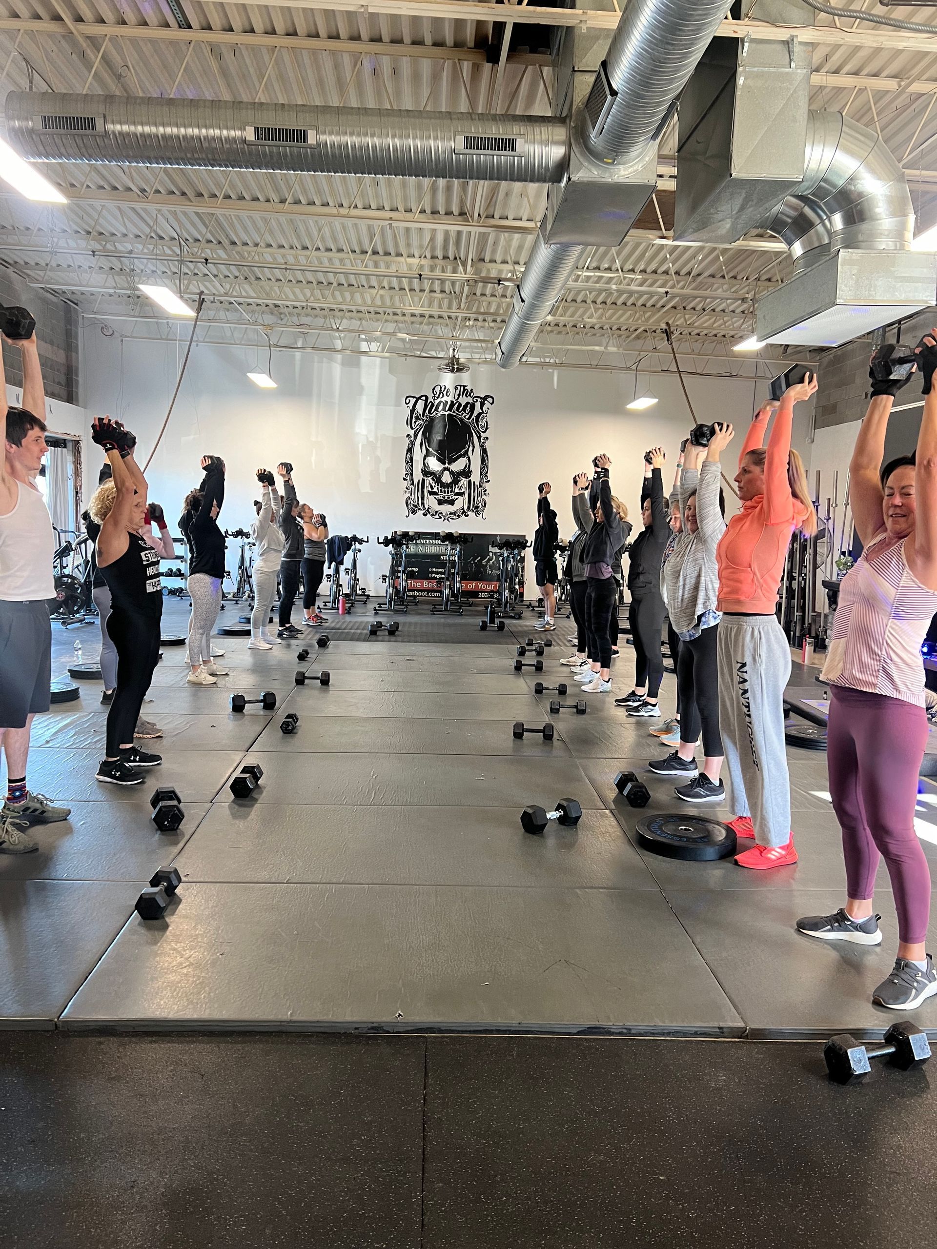 A group of people are doing exercises in a gym.