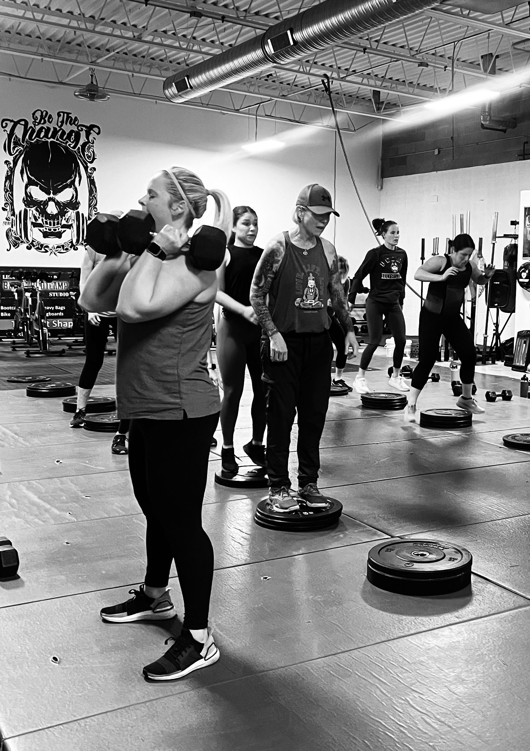 A group of people are doing exercises in a gym.
