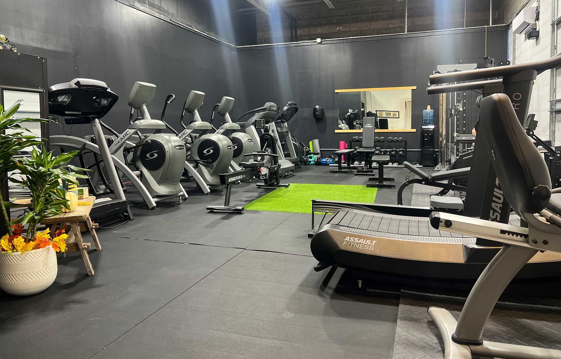 A gym filled with a variety of exercise equipment