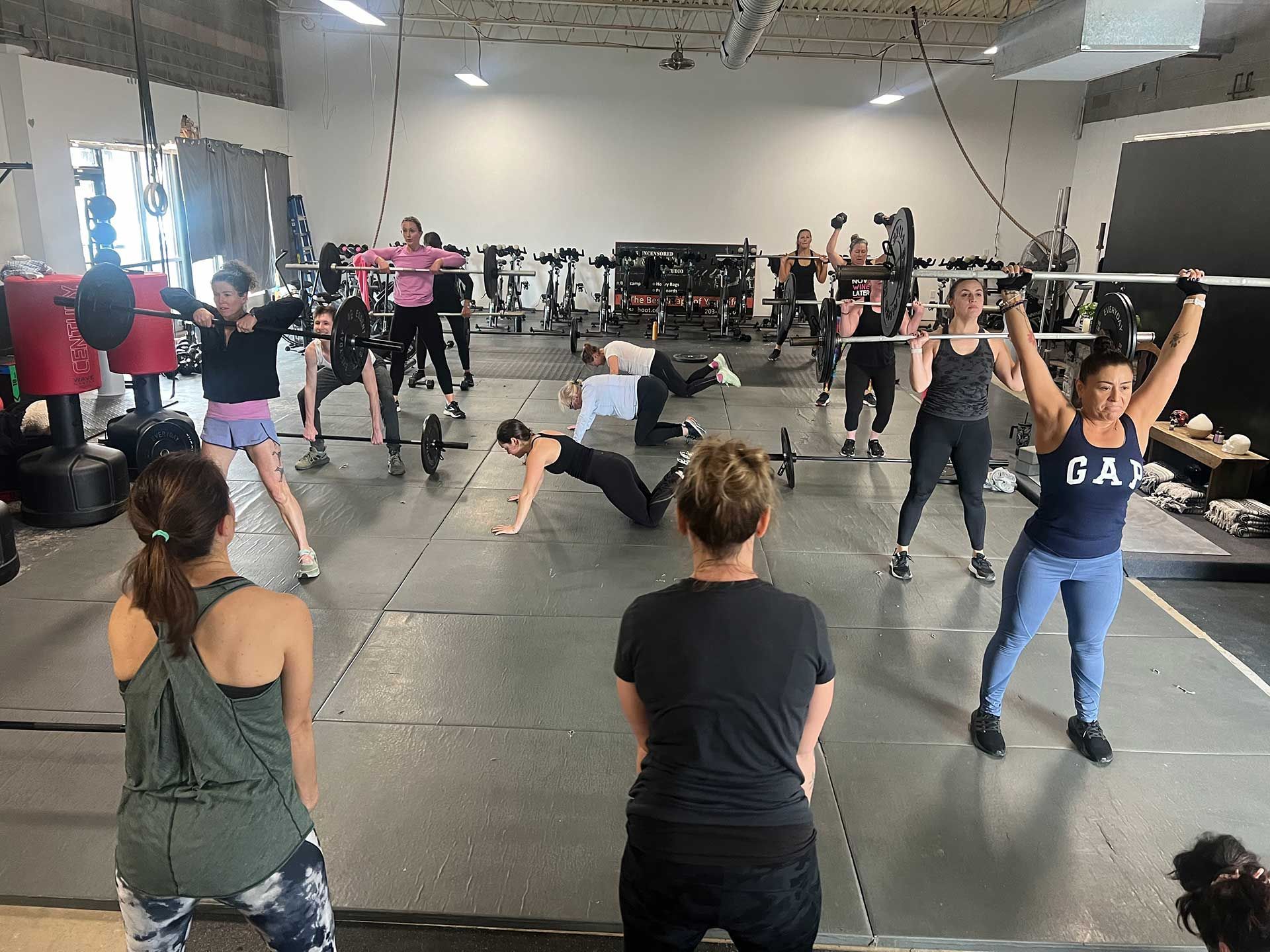 A group of women are doing exercises in a gym