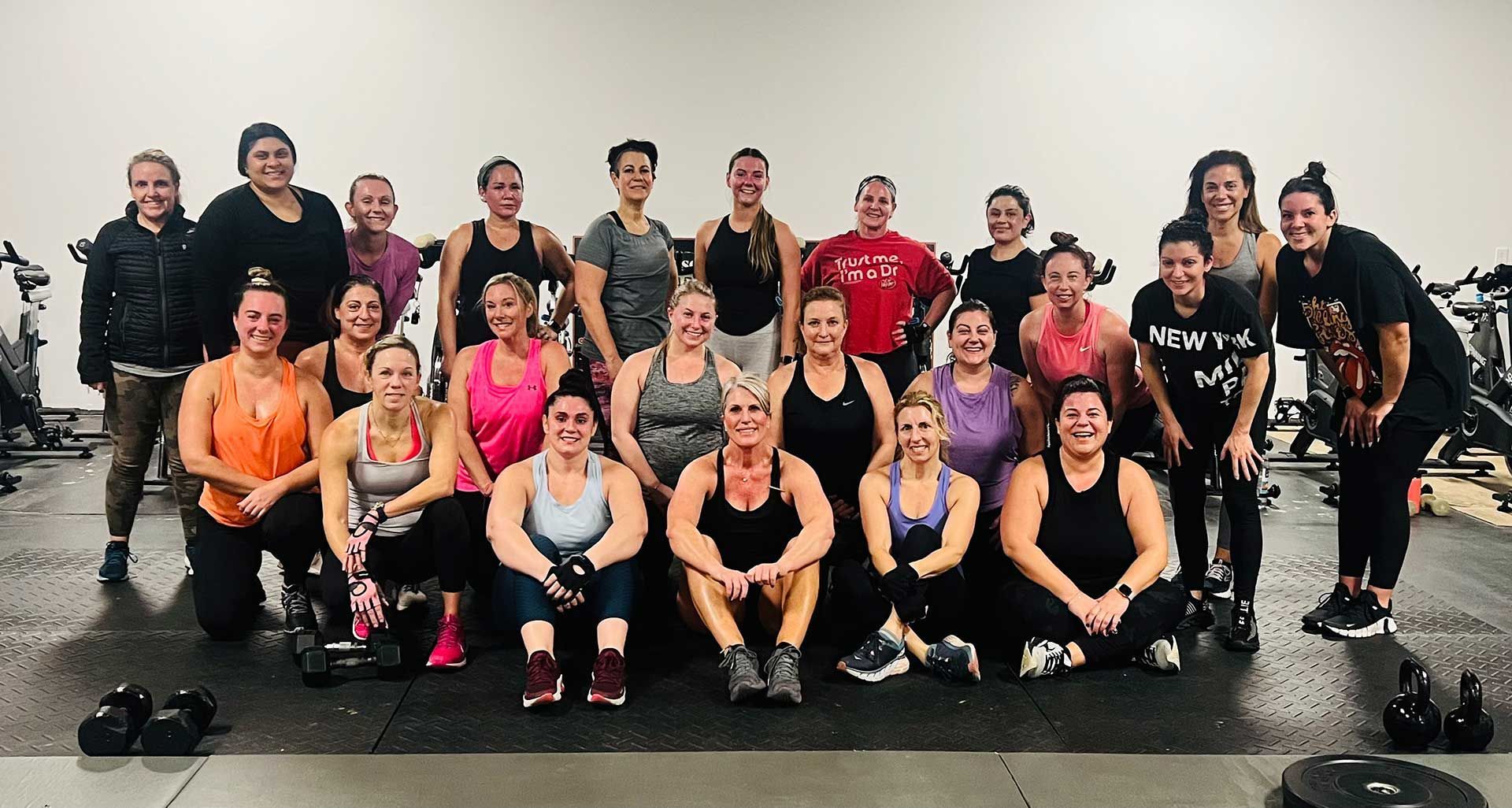 A group of people are posing for a picture after their workout