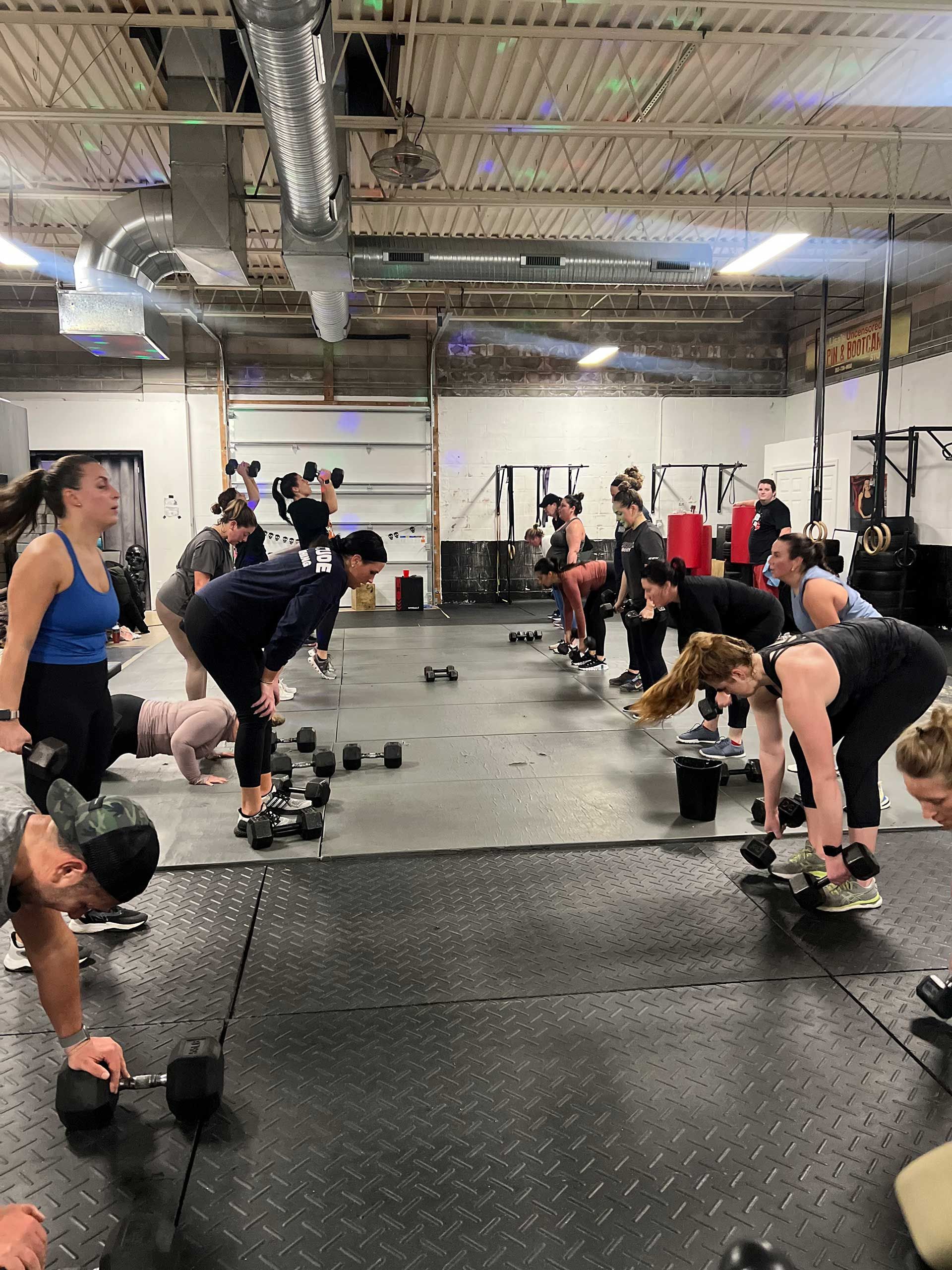 A group of people are lifting dumbbells