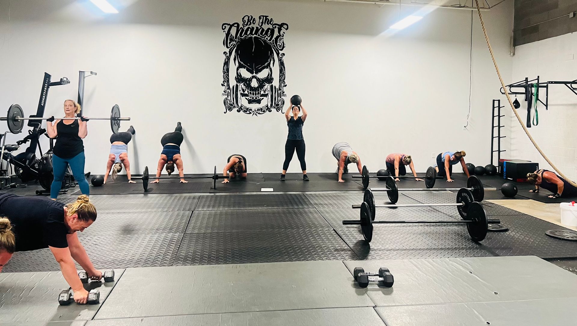 A group of people are doing exercises in a gym.