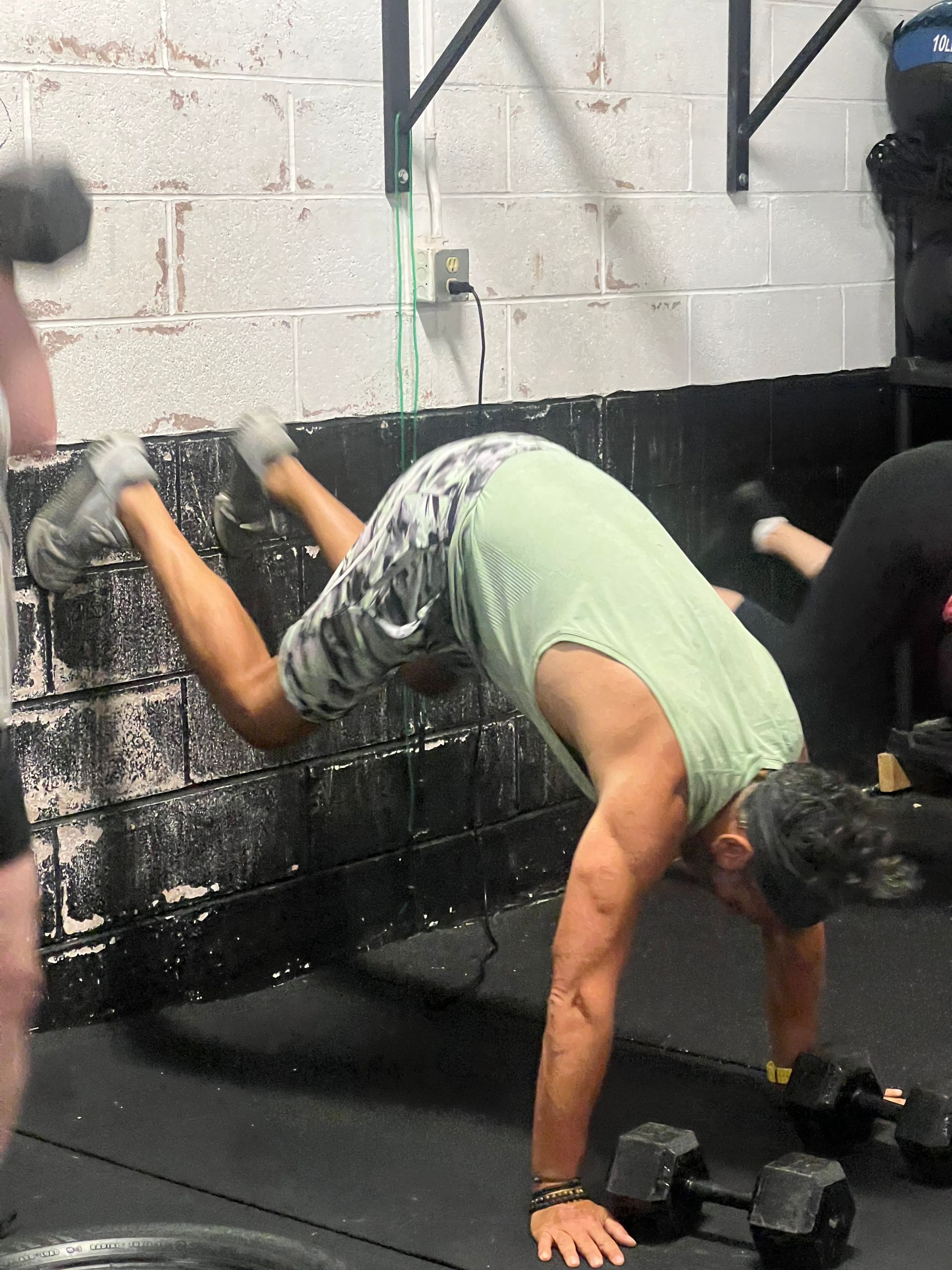 A man is doing a handstand in a gym