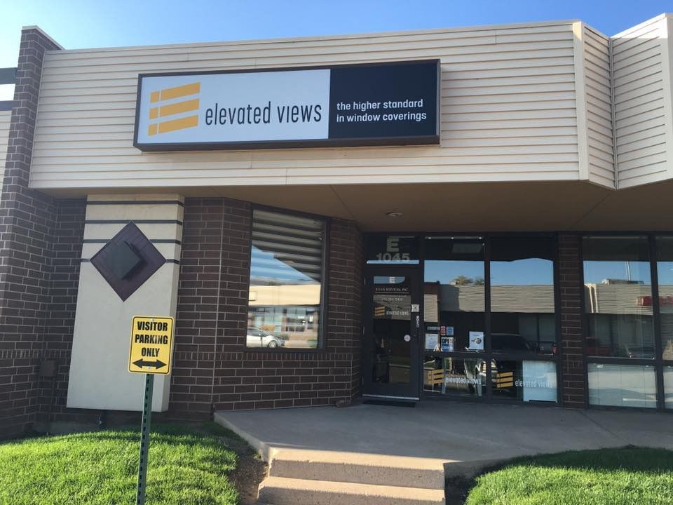Exterior of Elevated Views office building with sign, entrance, and 