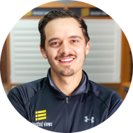 Man smiling in a zip-up jacket with 