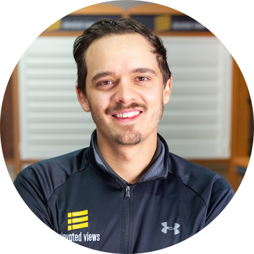 Man smiling in a zip-up jacket with 