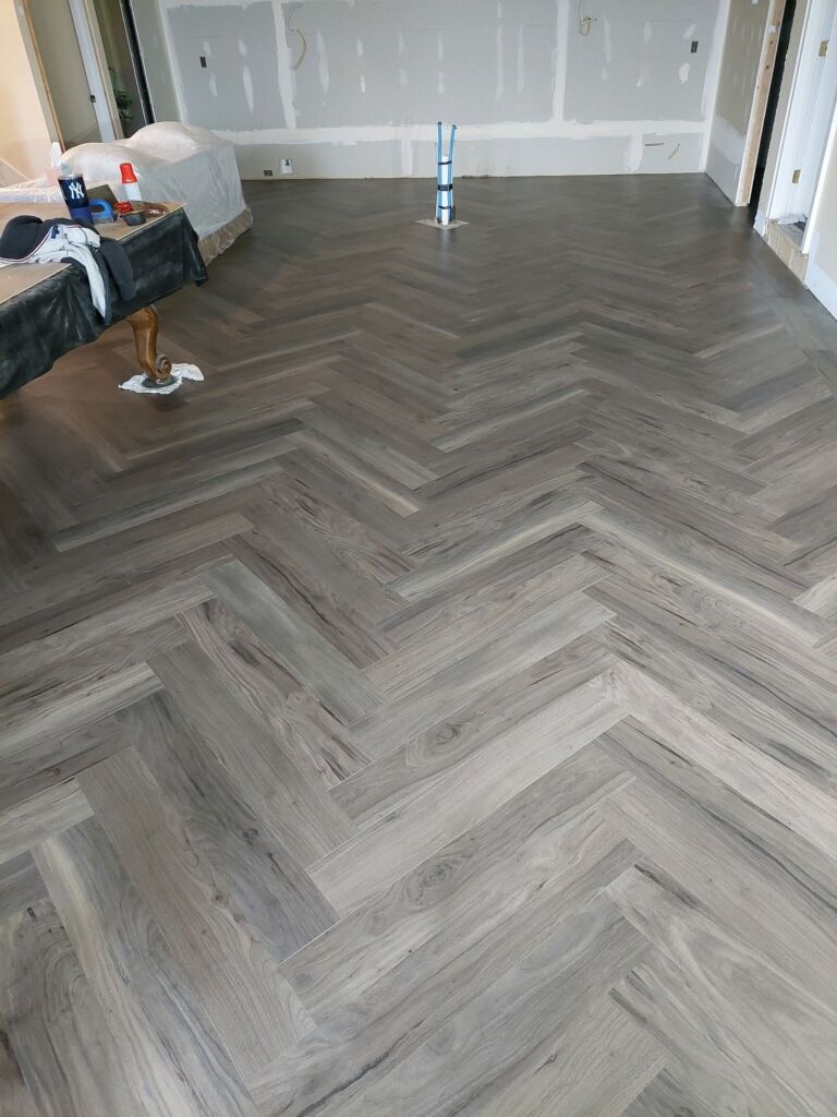 A room with a herringbone pattern on the floor.