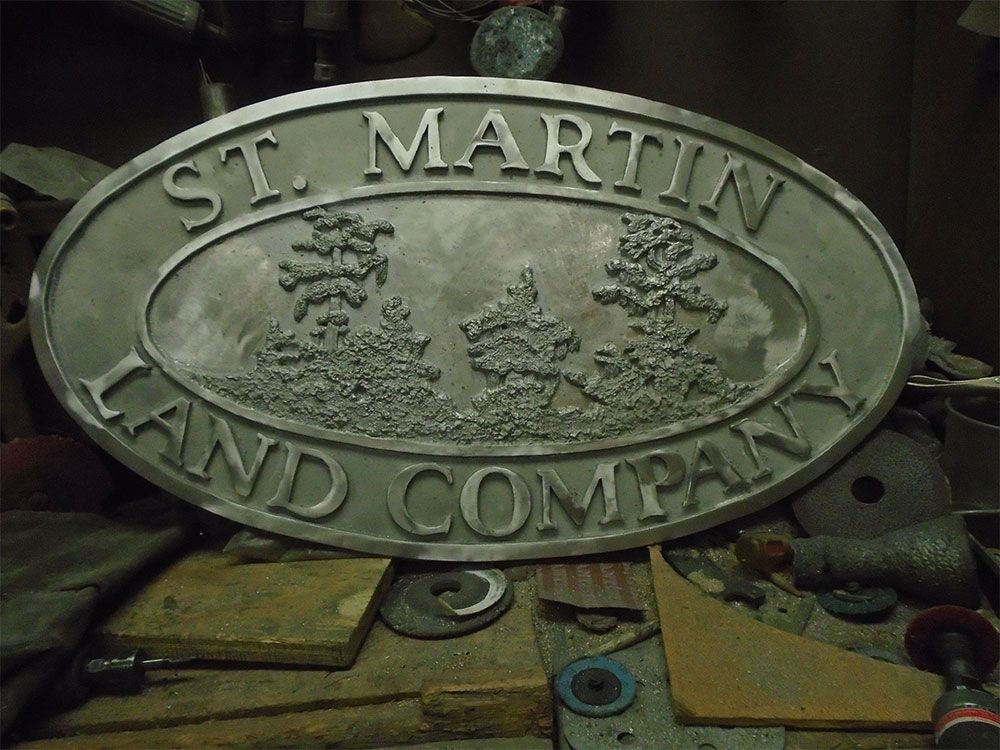 An oval metal sign reading