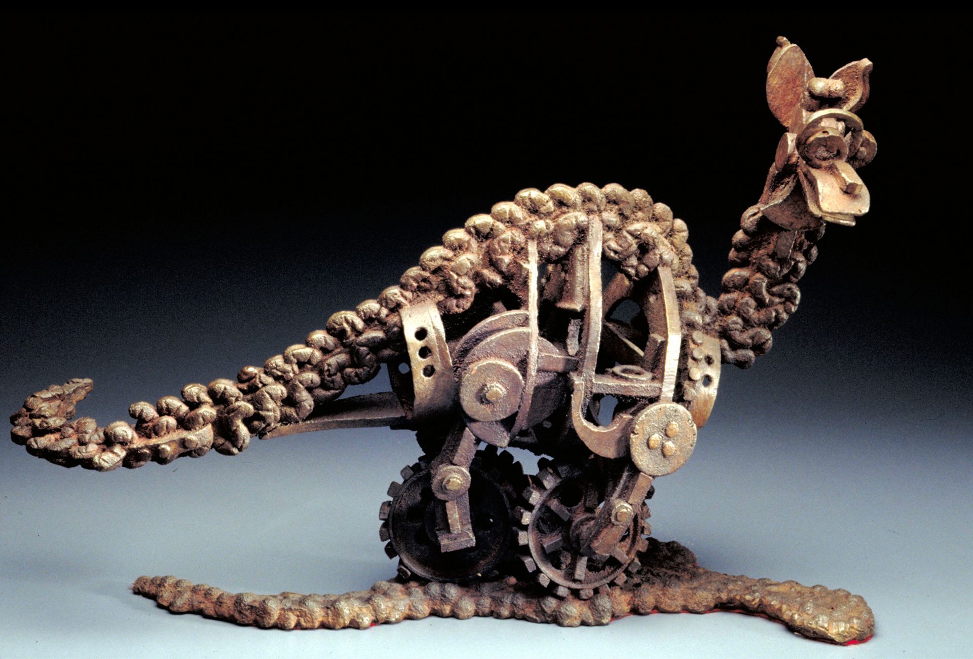 Mechanical kangaroo sculpture made of metal parts on a dark background