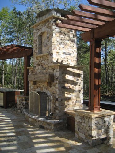 Stone fireplace with pergola, outdoor patio.