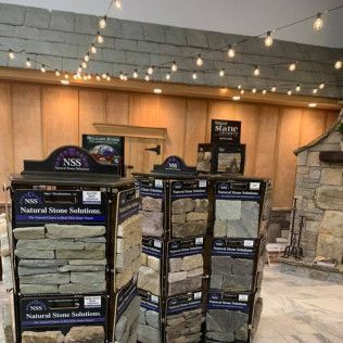 Stone display at a Natural Stone Solutions showroom. Display racks hold samples of various stone types.