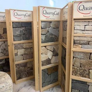 Stone samples displayed on wooden racks with 