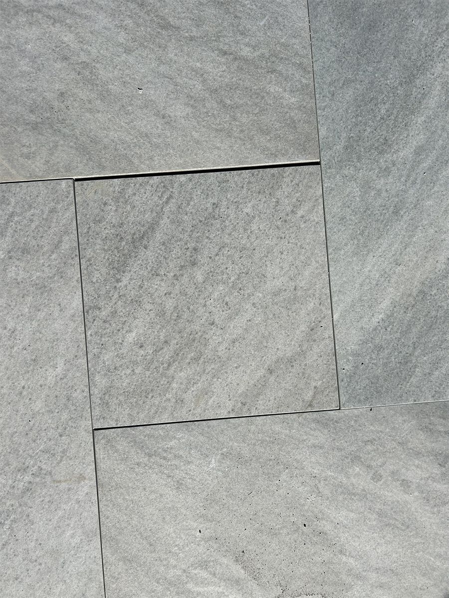 Gray stone tiles arranged in a grid pattern.