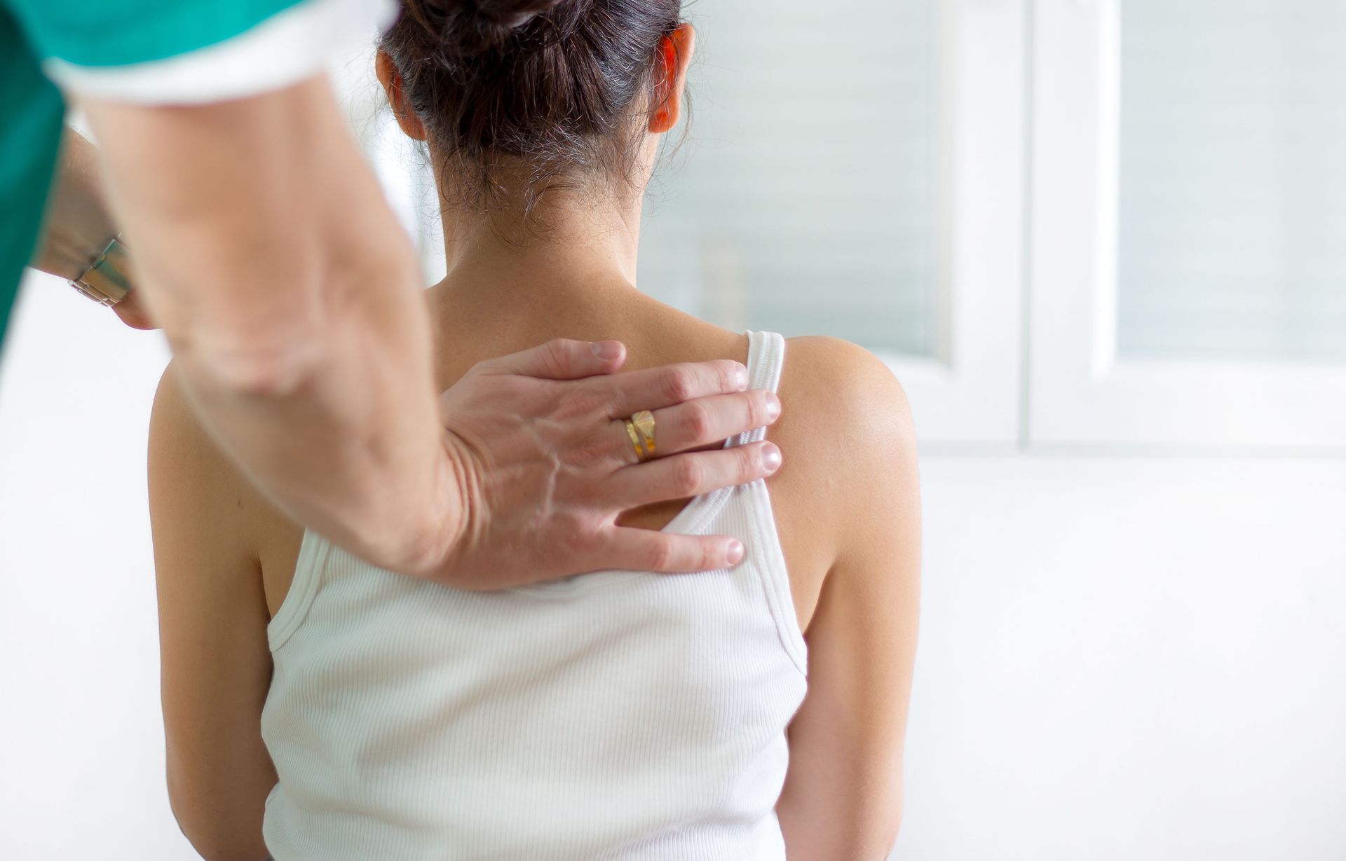 A woman is getting a massage from a doctor.