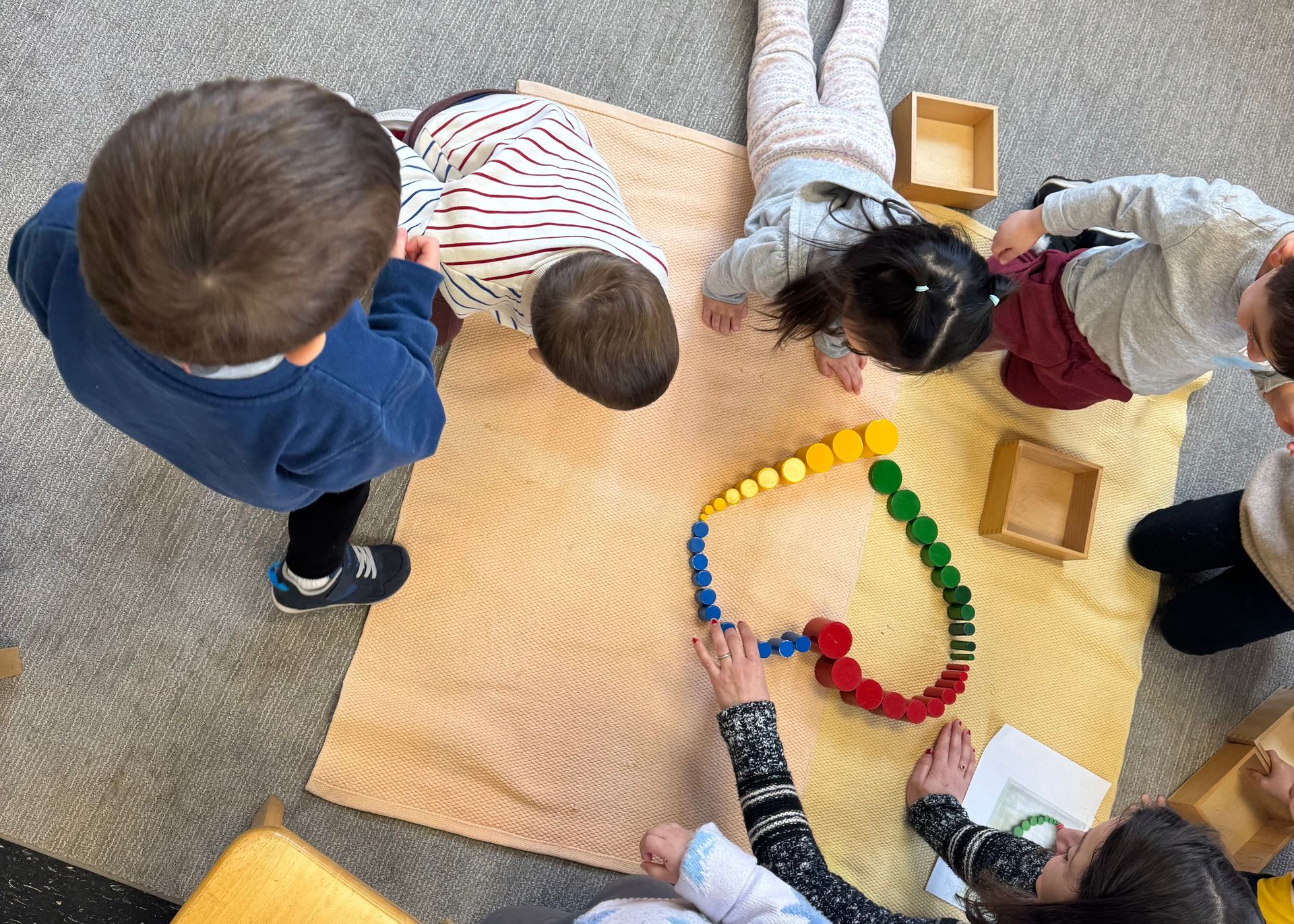 children building a heart out of multi colored blocks