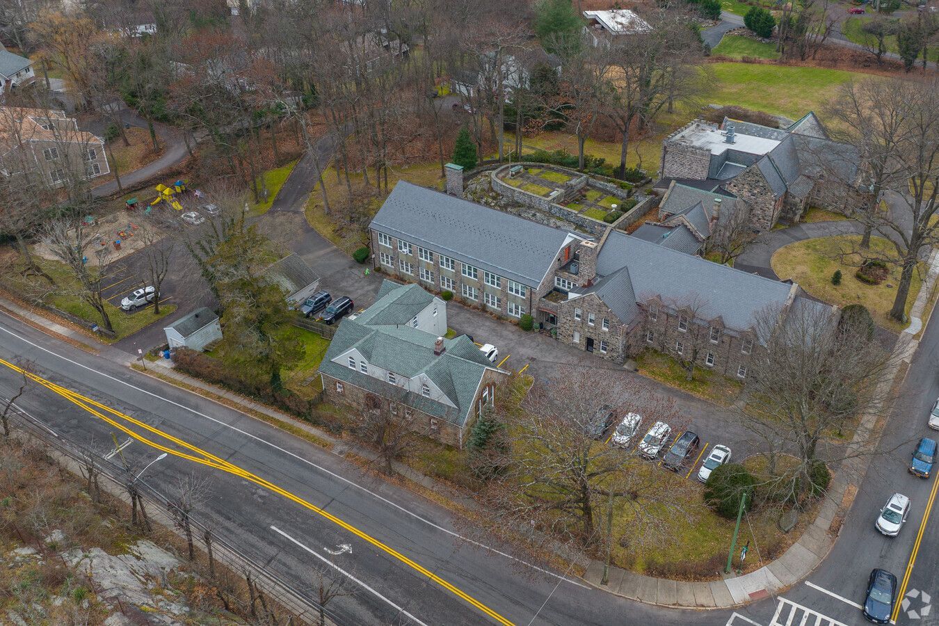 An aerial view of a large building next to a road.