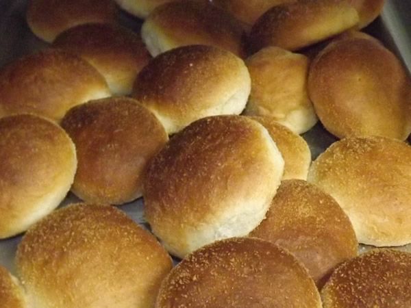 Pile of golden-brown dinner rolls.