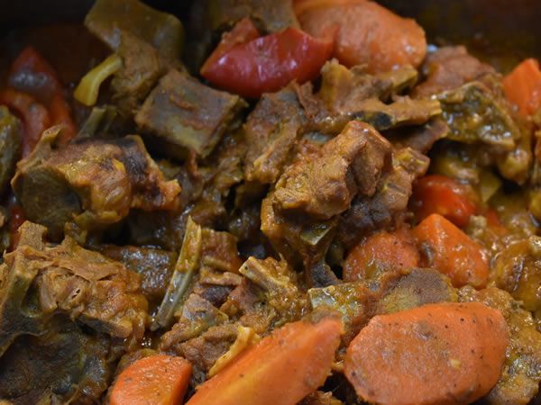 Stewed meat with carrots and tomatoes.