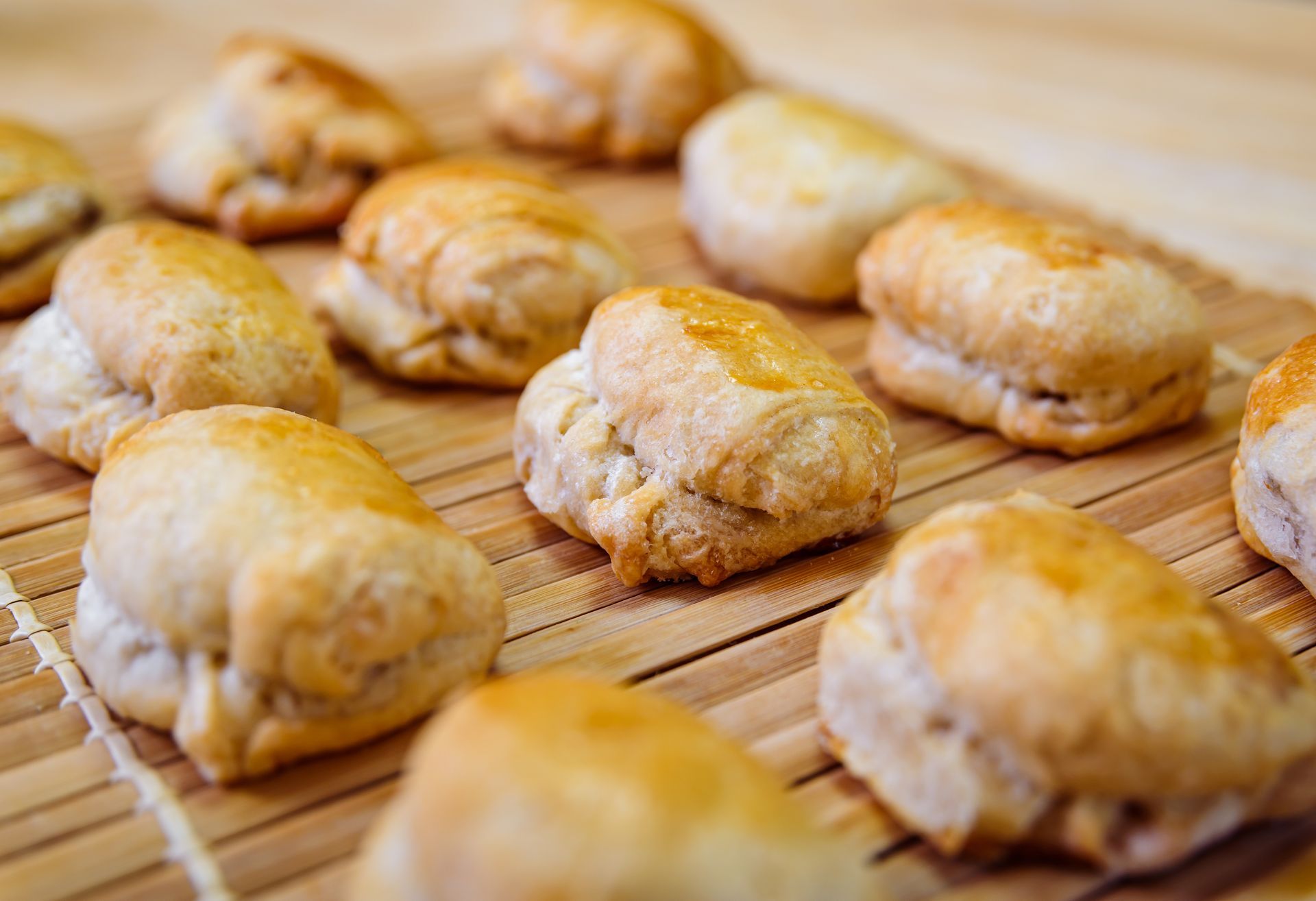 Golden baked pastries on a bamboo mat.