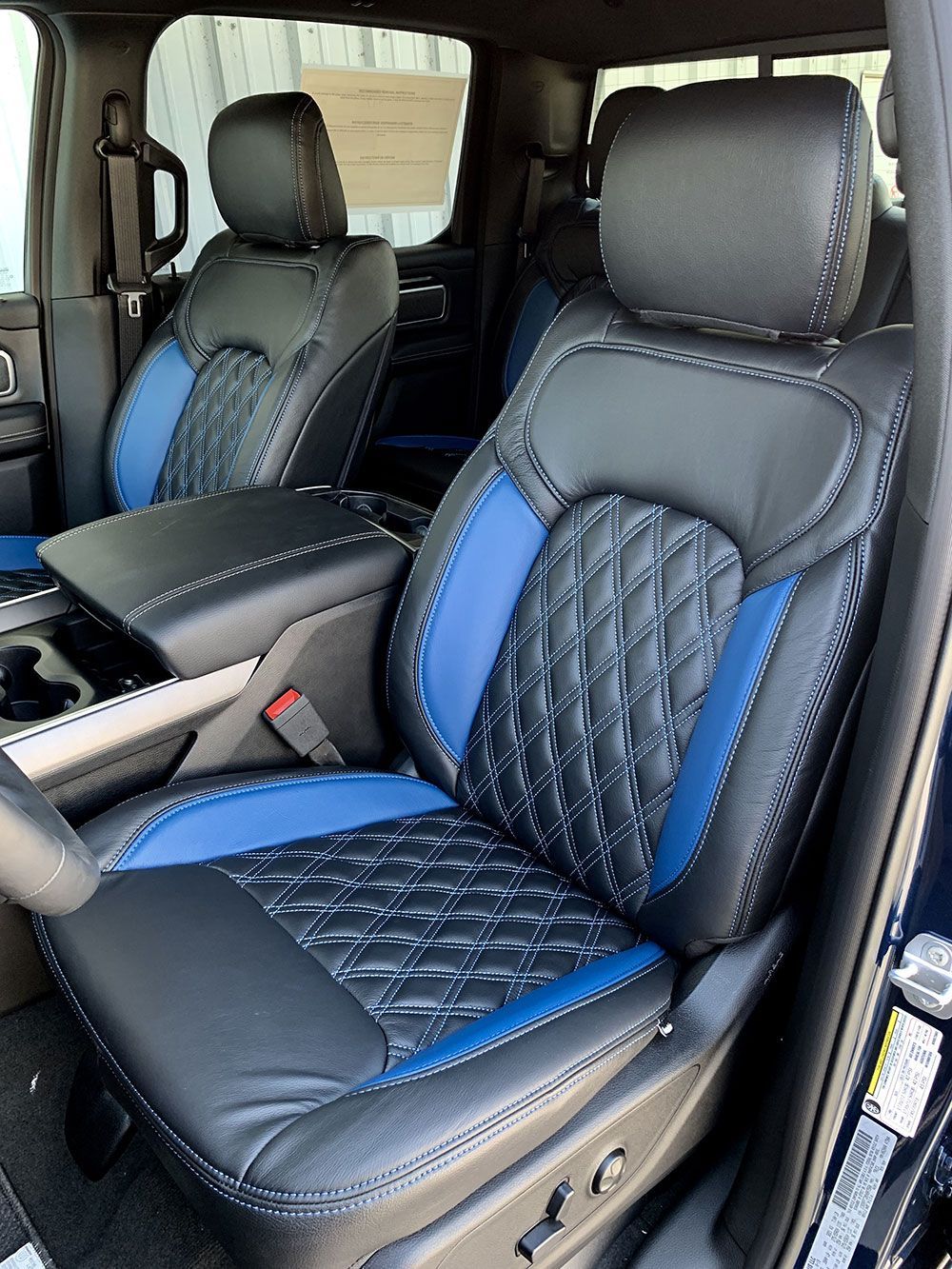 Black and blue leather truck seats with diamond stitching.