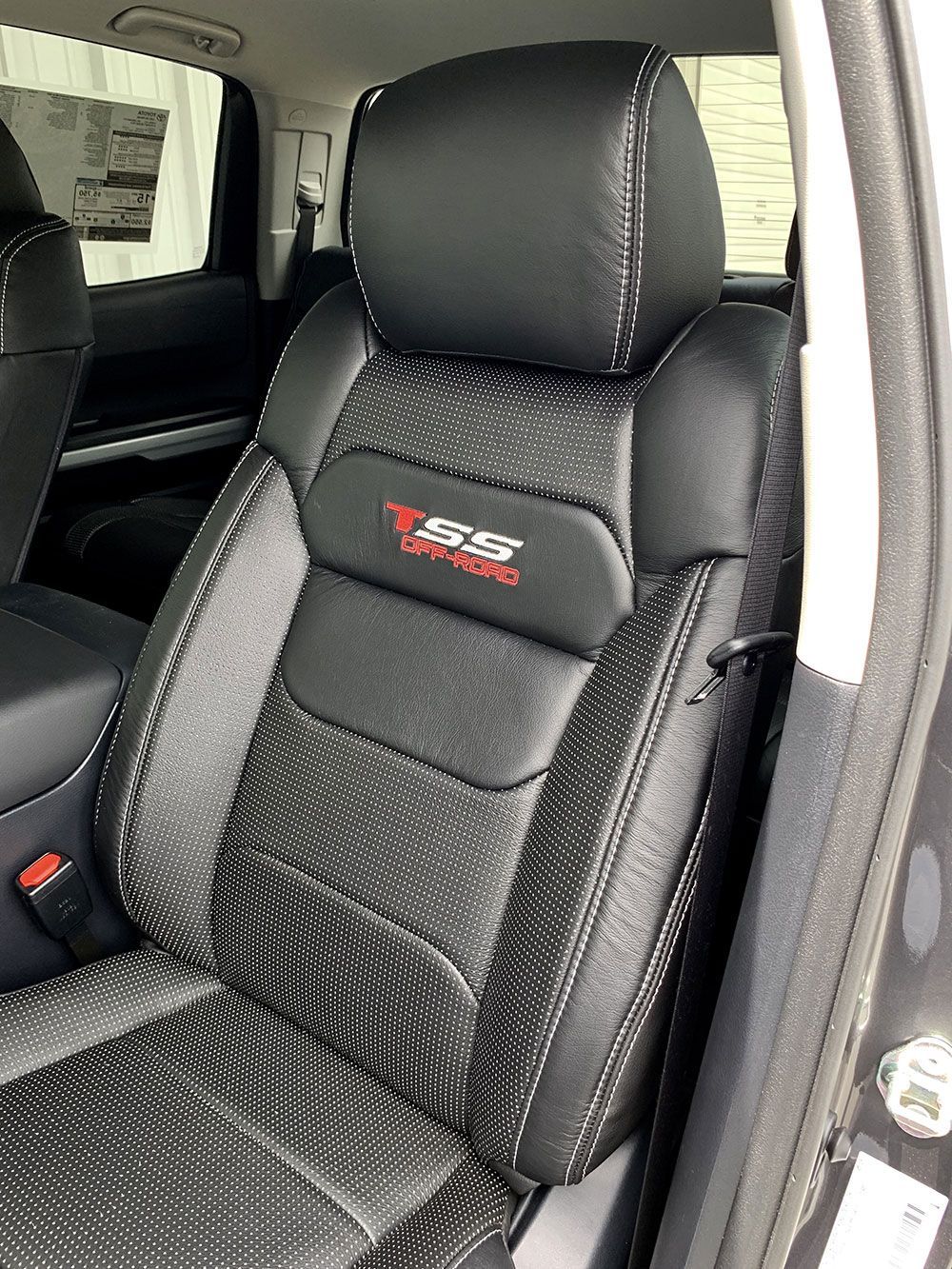 Black leather truck seat with red 