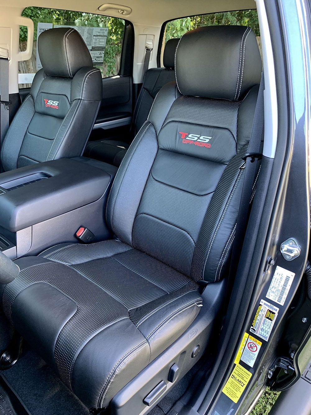 Black leather car seats with white stitching and 