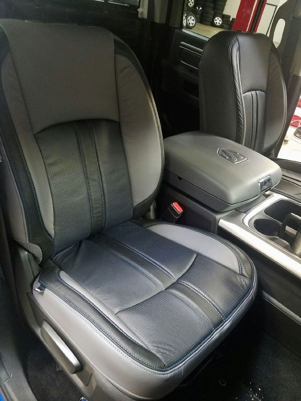 Gray and black car seat with a center console.