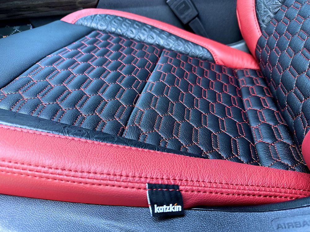 Black and red Katzkin car seat with quilted pattern and red stitching.
