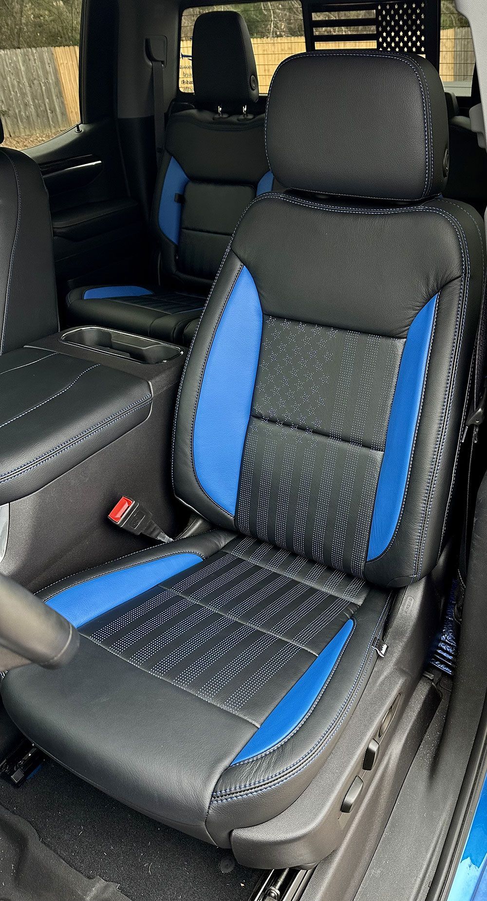 Blue and black leather car seat with blue accents.