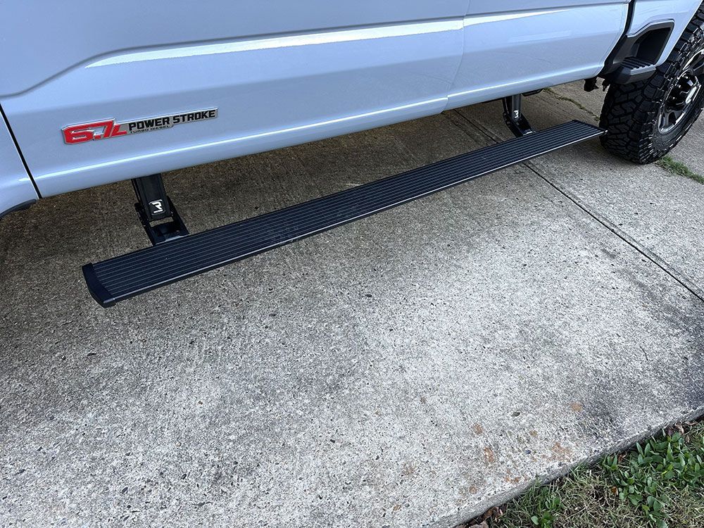 Gray truck with a black running board; 