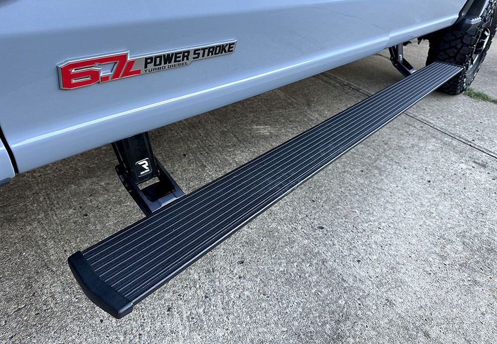 Black running board on a gray truck with 