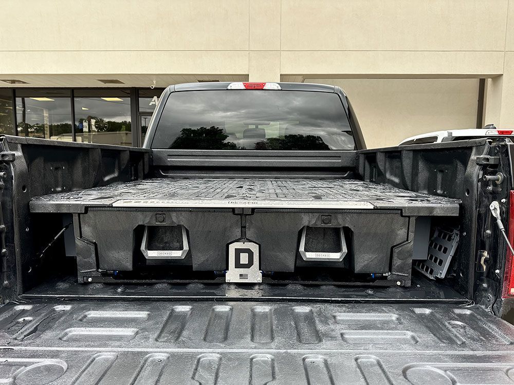 Truck bed with a black storage system installed.