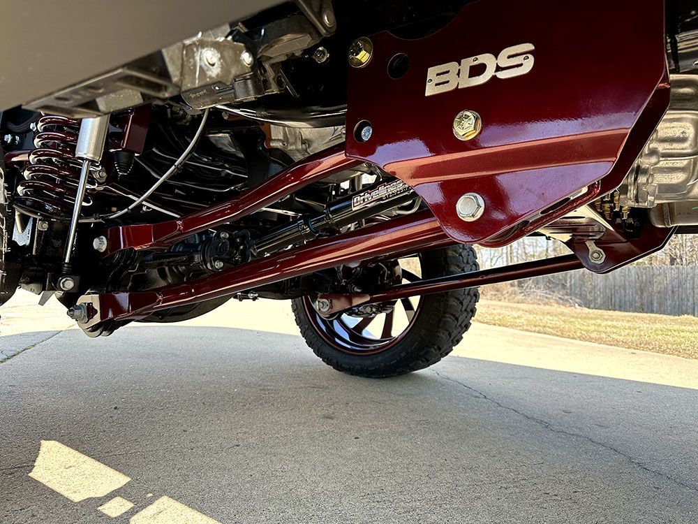 Red BDS suspension lift kit installed on a truck, with black tires and chrome detailing.