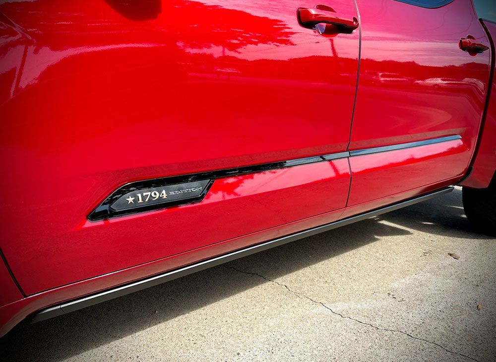 Red pickup truck door with black trim and 