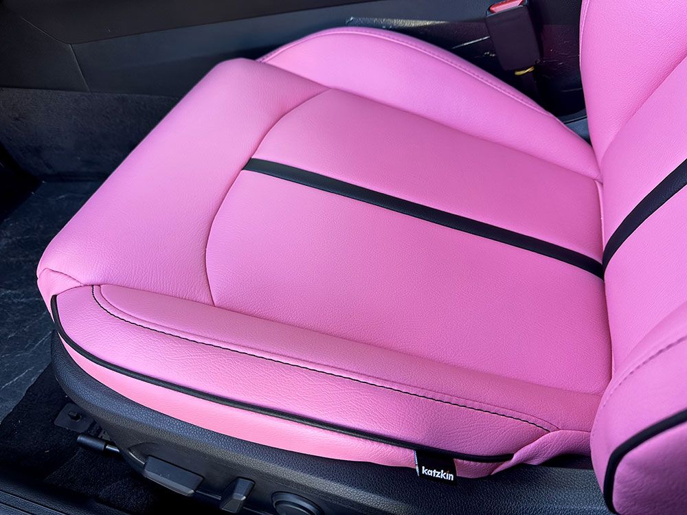 Pink car seat with black accents.