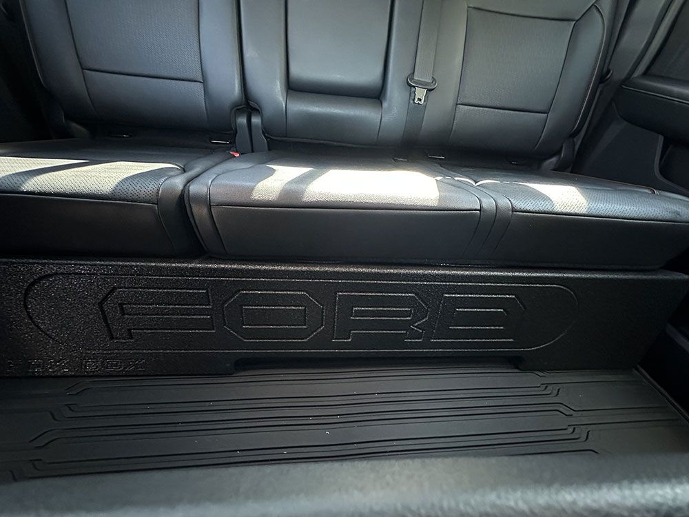 Black car interior showing a speaker box with 