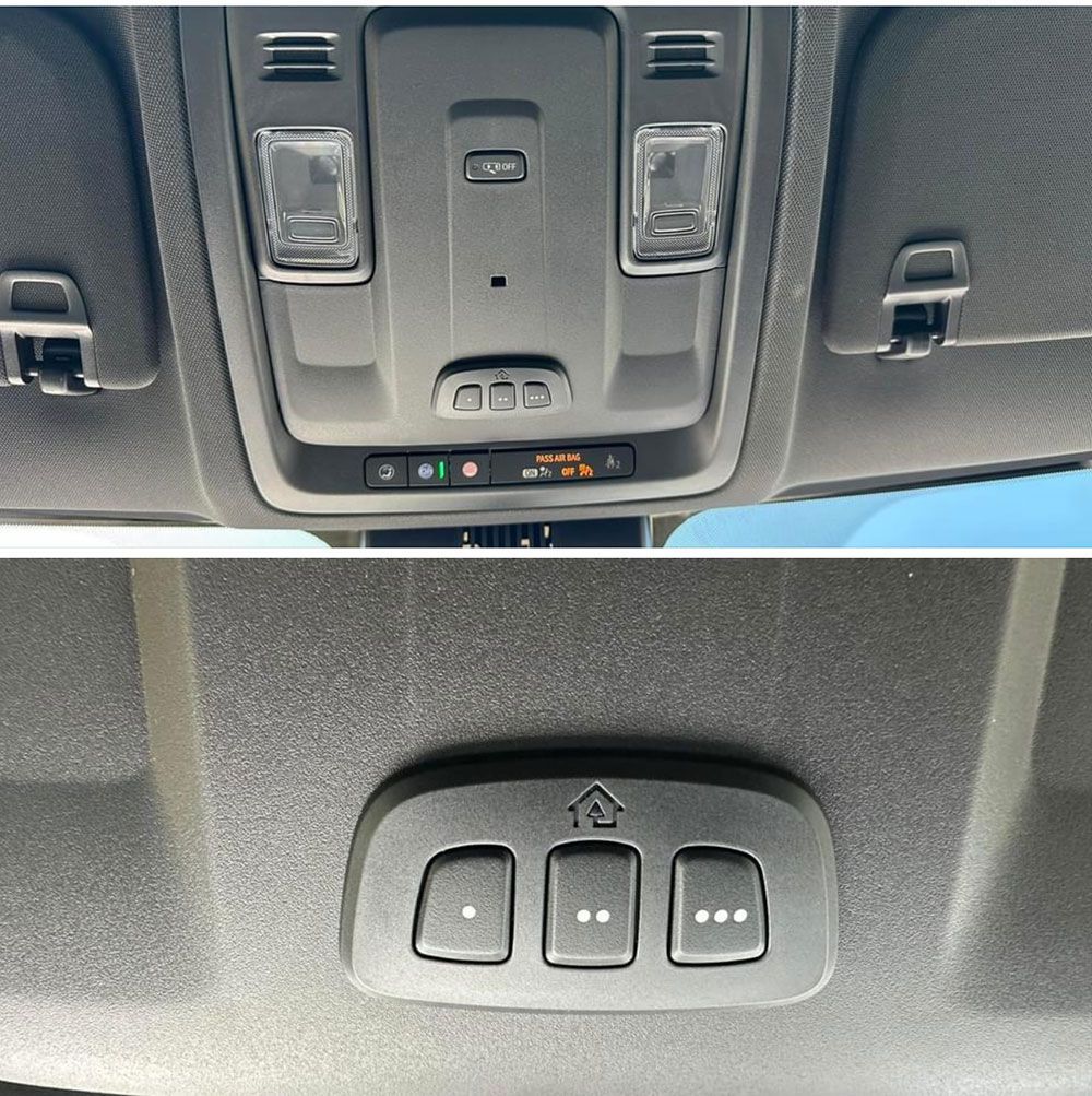 Overhead car console with lights, buttons, and sun visors; garage door opener with three buttons.