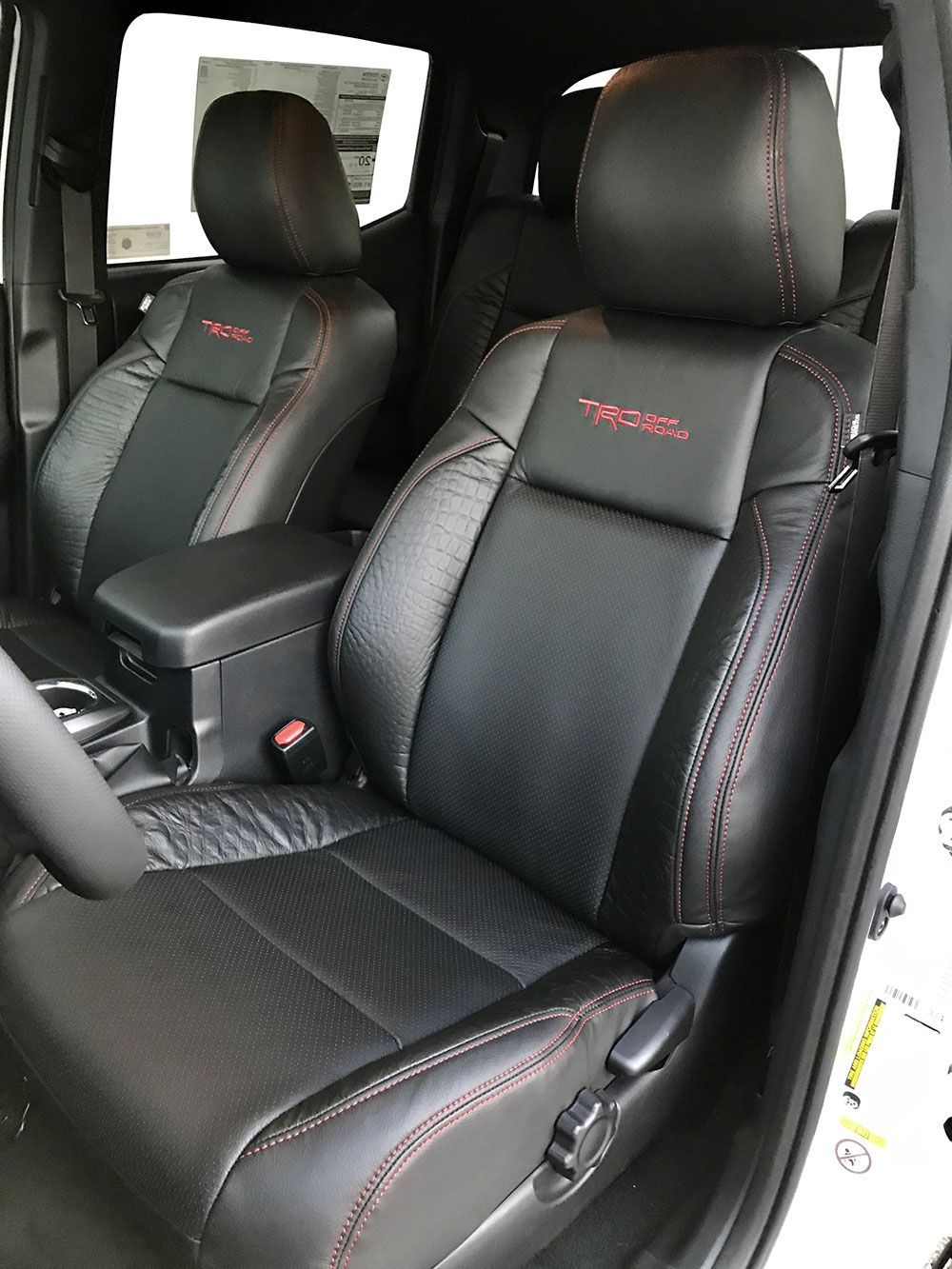 Black leather vehicle seats with red stitching; 