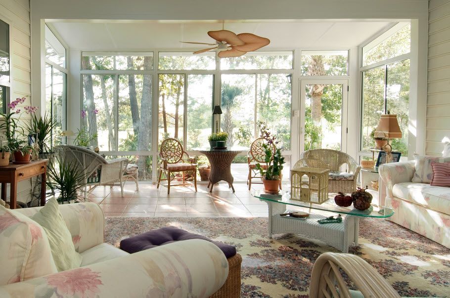 A living room with a lot of furniture and a ceiling fan