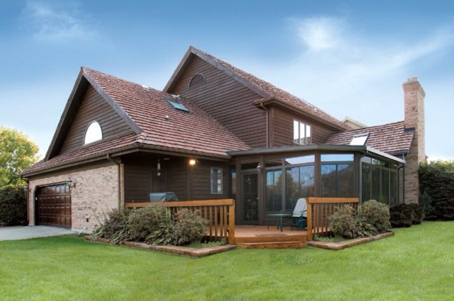 A large house with a screened in porch and a garage