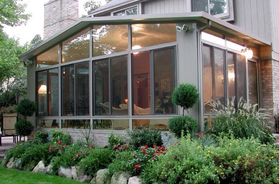 A house with a screened in porch and a lot of windows