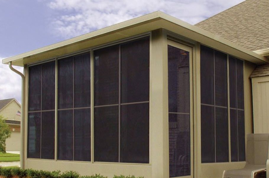 A screened in porch on the side of a house